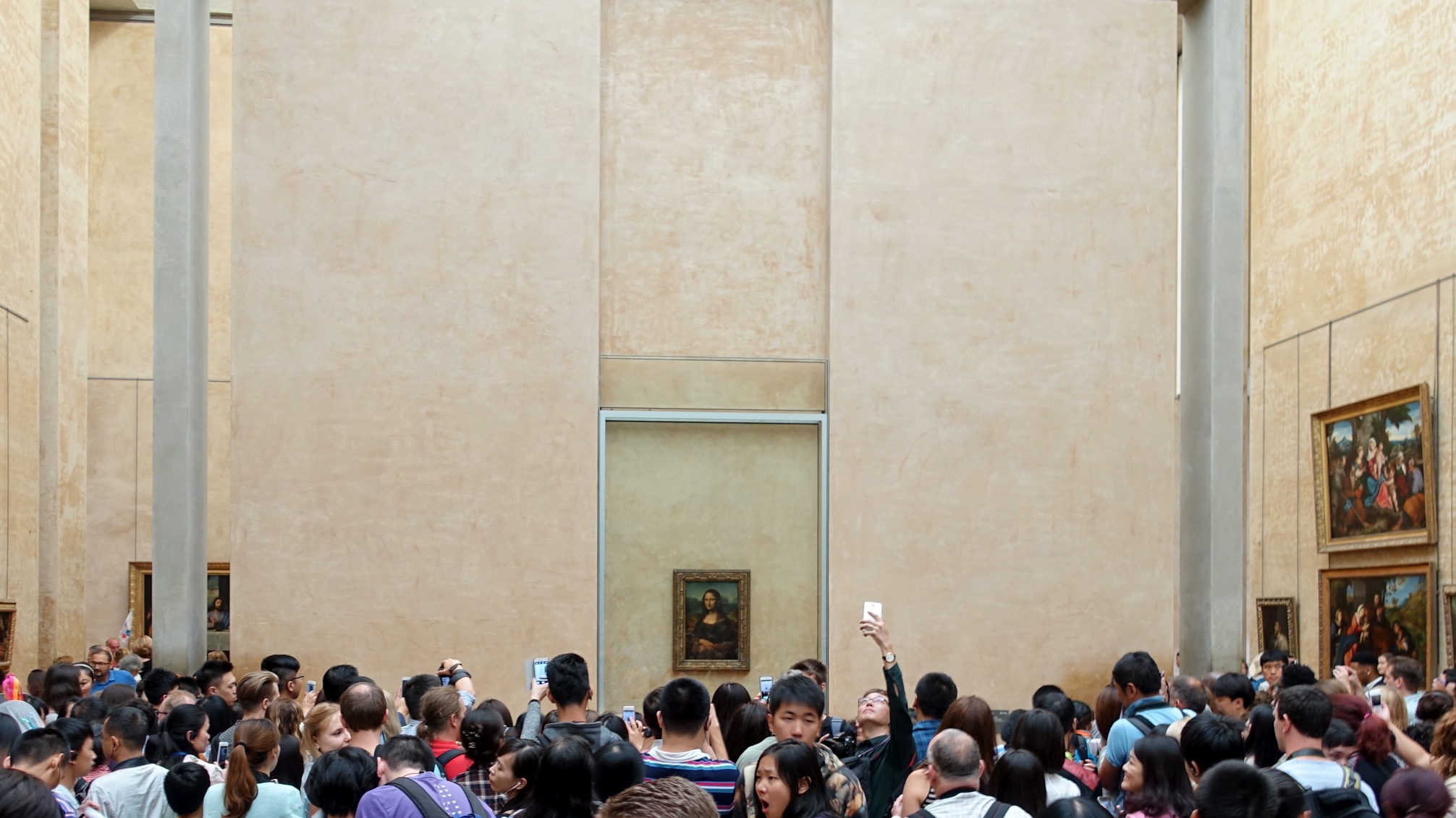 Group of people taking in the view of Mona Lisa in Paris, France