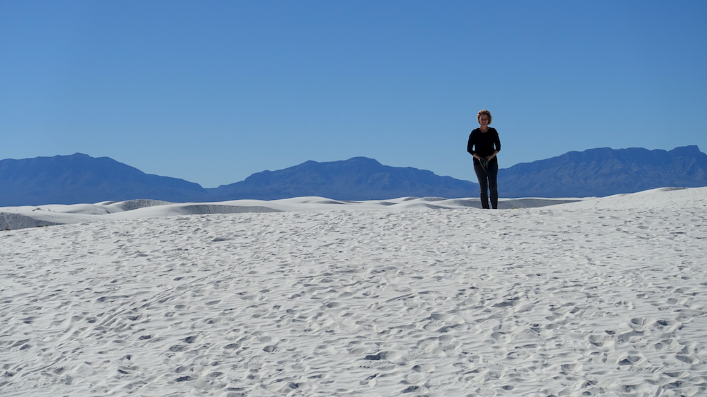 Woman standing in the white sand of White Sands National Monument.