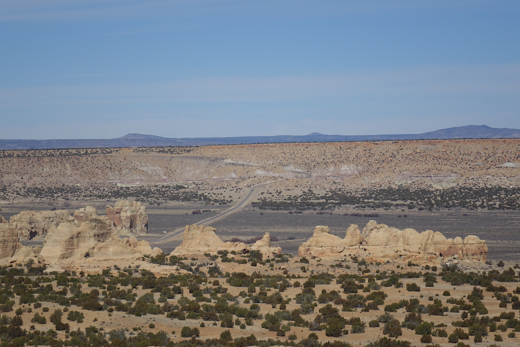Road winding through the rocky formations scattered across the desert landscape.