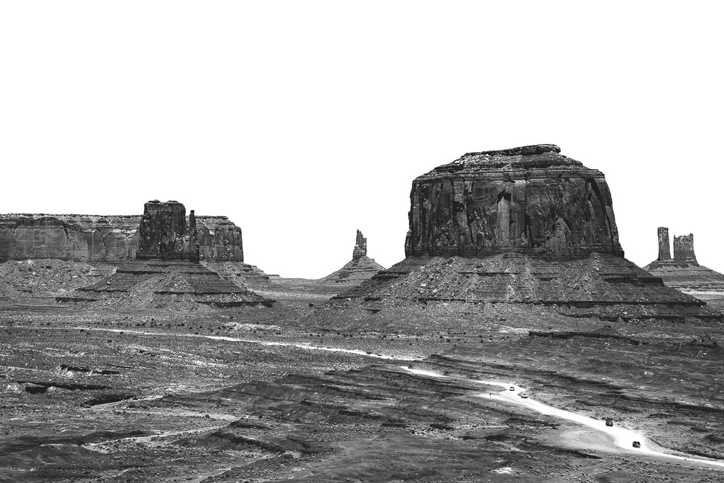 Sporadic and sudden rock formations that rise up from the desert landscape of Monument Valley.