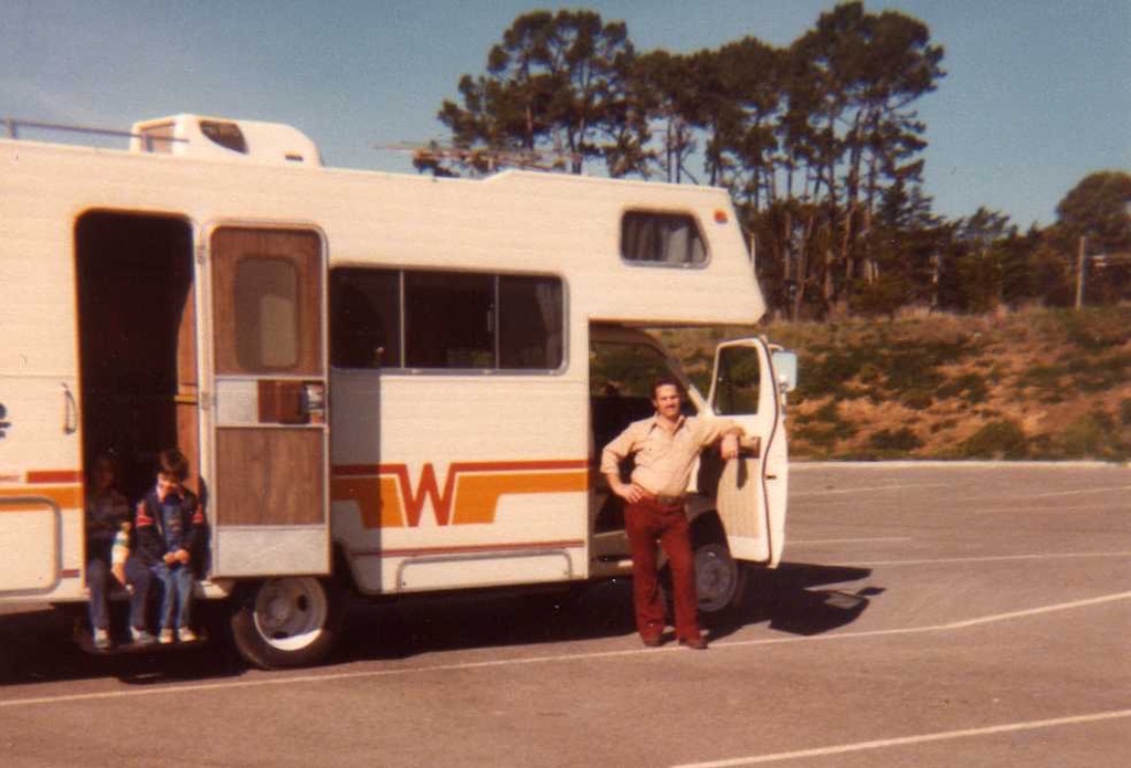 Old photo of gentleman and two kids next to their Winnebago.