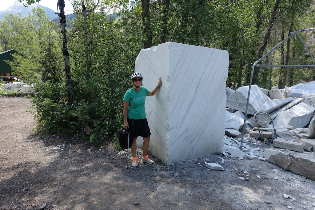 Sculptor standing next to massive block of Colorado Yule Marble.