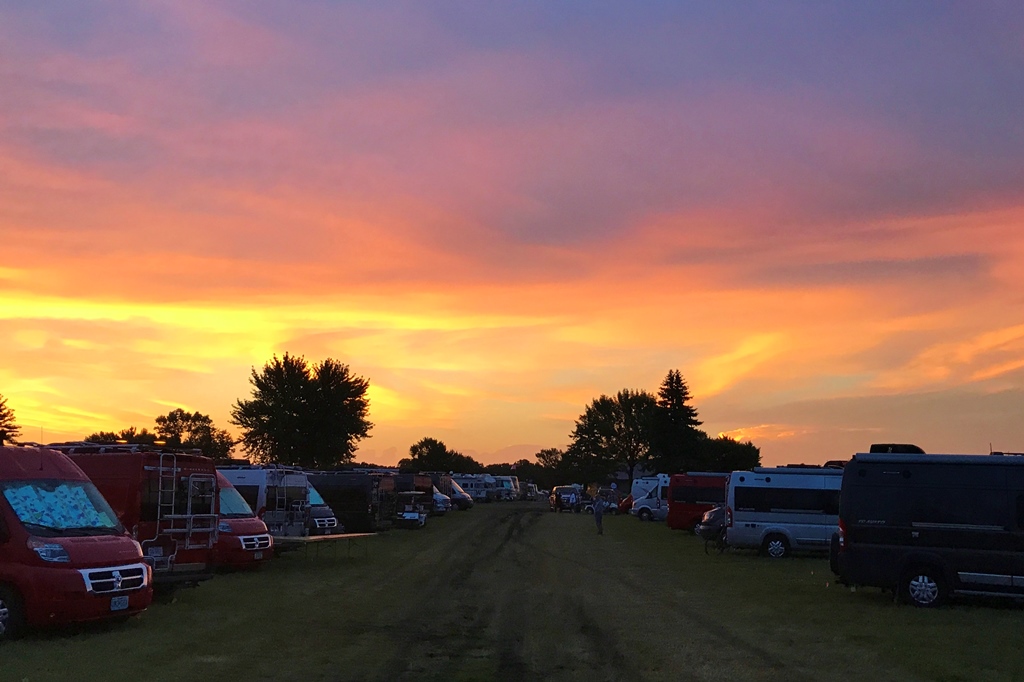 Beautiful sunset above rows of Winnebago class B products.