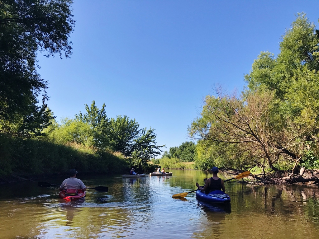 People kayaking down the Winnebago River.