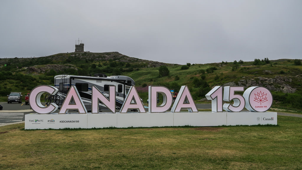 Motorhome behind "Canada 15" sign