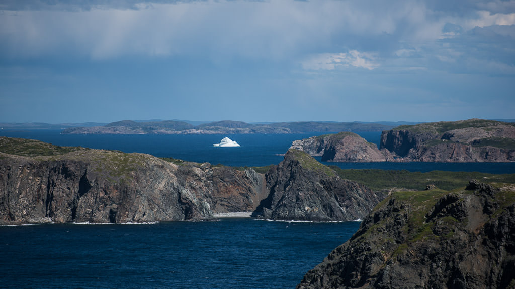 Iceberg in the middle of water filled with rocky terrain