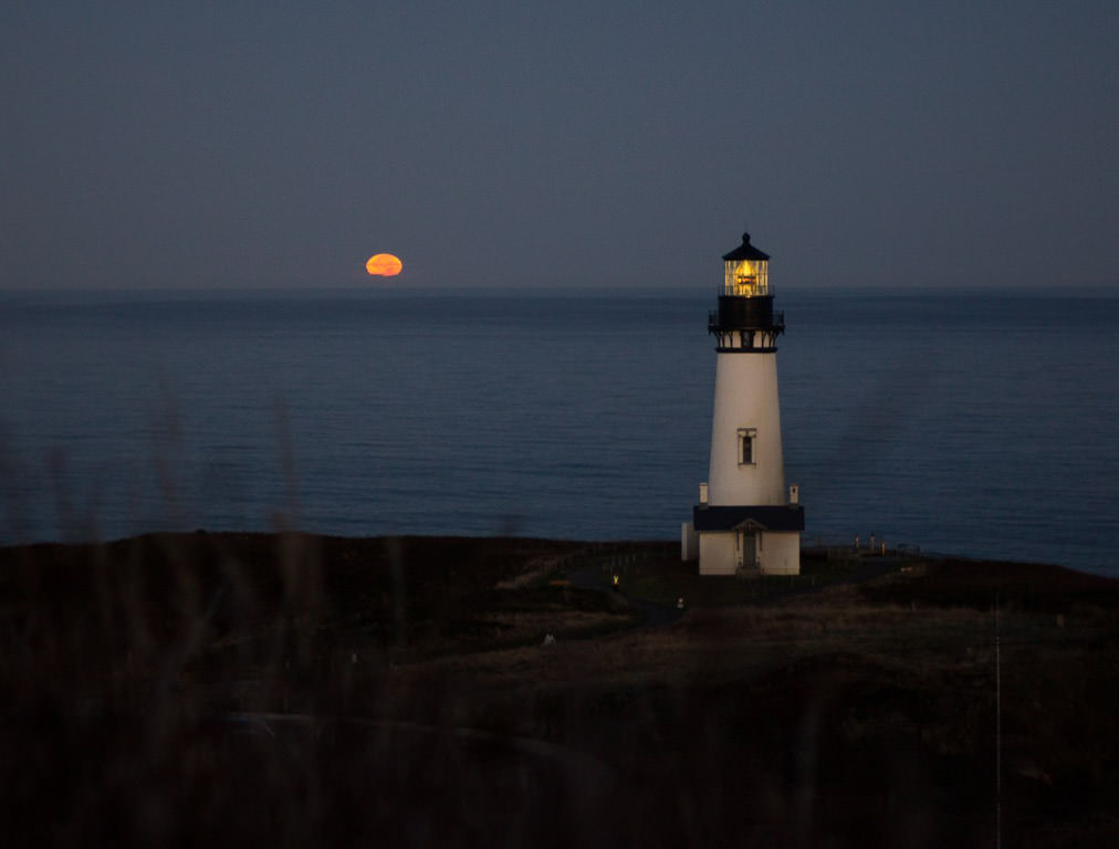 Lighthouse with pink moon in background