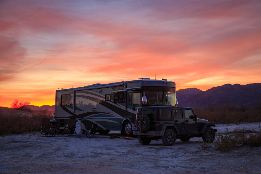Winnebago Journey with moutains and setting sun behind