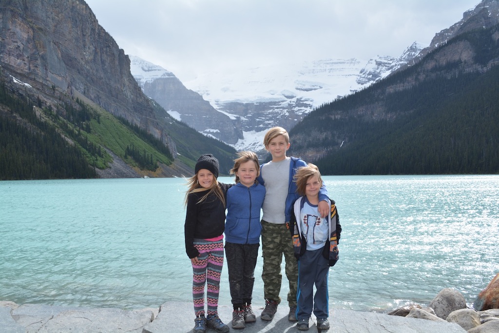 Royal kids in front of lake and mountains