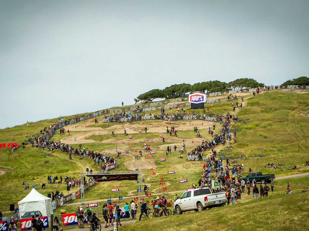 Crowds gathered at a biking event on a hillside
