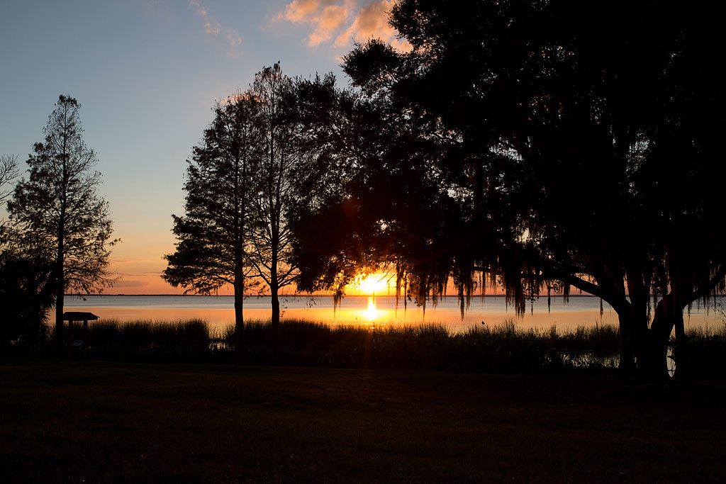 Sun setting over the water at Magnolia Park State Park Campground