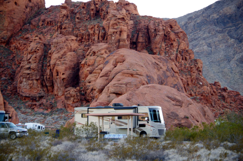 Winnebago parked in front of red rock formation in Valley of Fire 