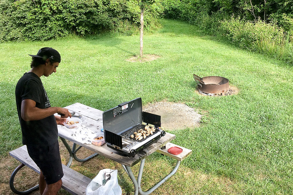 Jordan grilling on picnic table outside