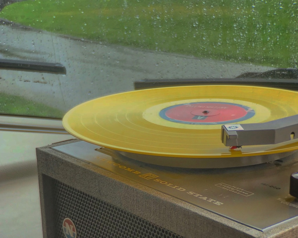 Record player playing a yellow record