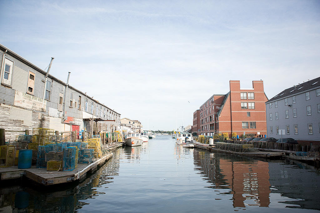 View down the water with buildings on either side in town of Portland, Maine