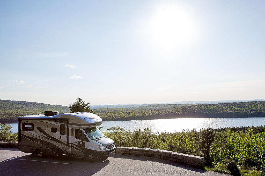 Winnebago View parked at a scenic overview with water below