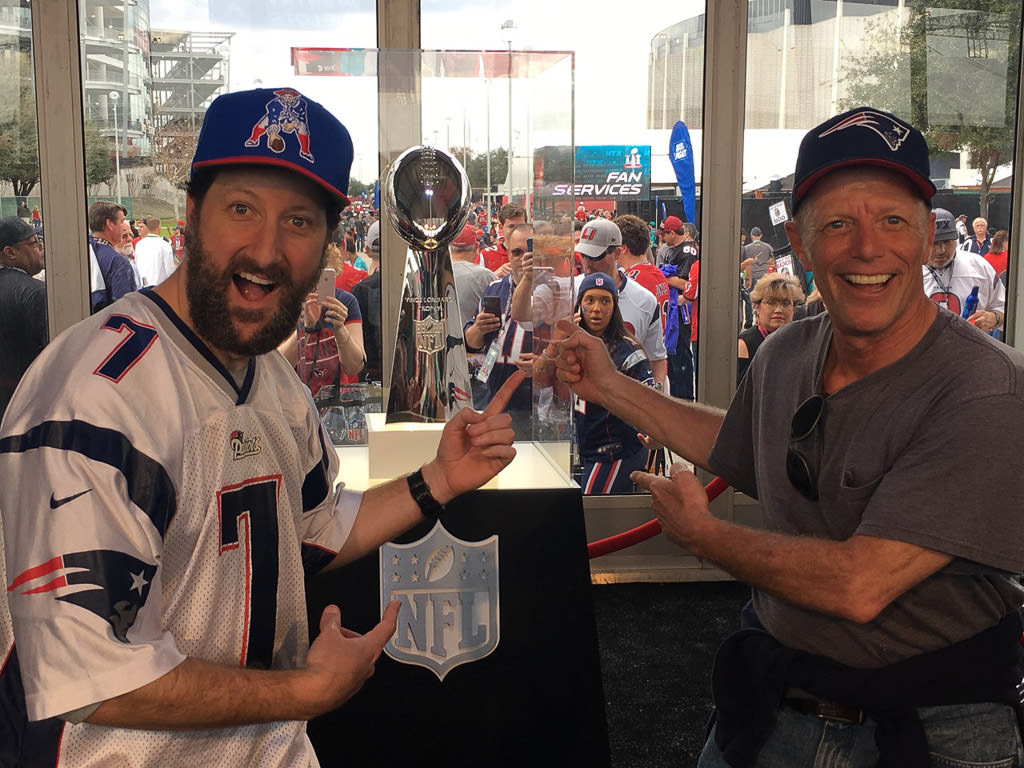 Alan and nephew pointing to trophy at Superbowl game