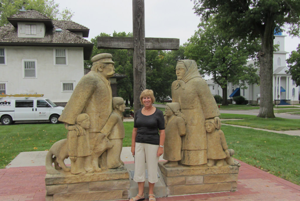 Ruth standing between two statues.