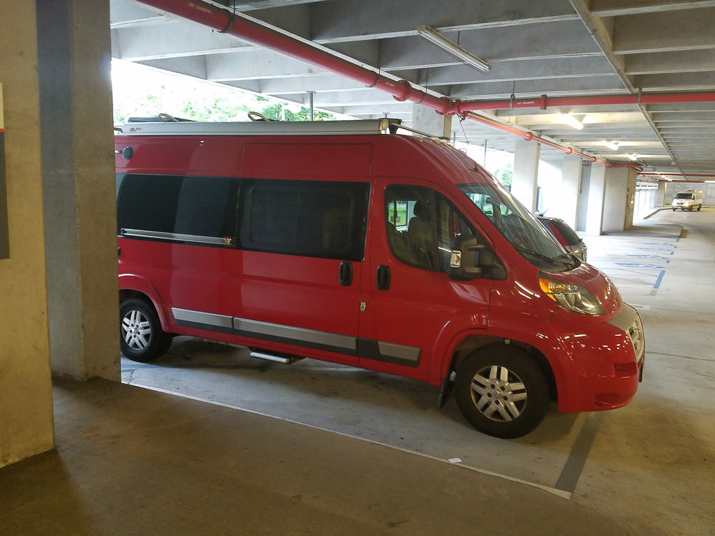 Red van parked in parking garage