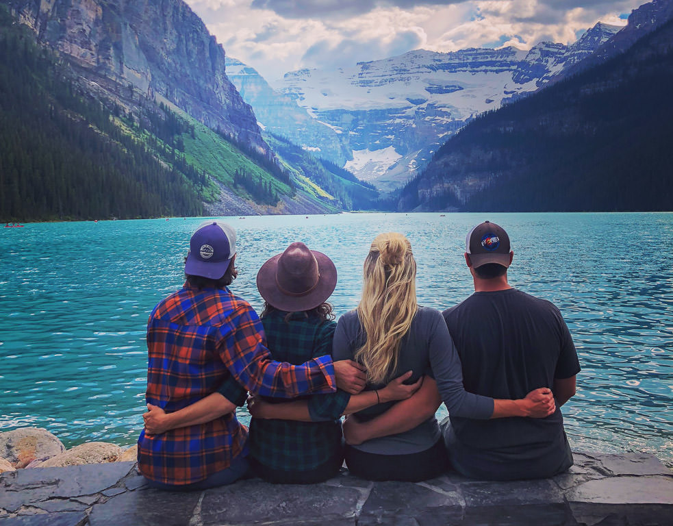 Pete, Jordan, Lindsay, and Dan sitting in front of the water in Banff