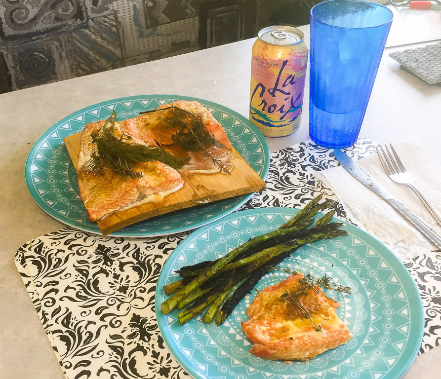 Two blue plates with salmon and asparagus on them