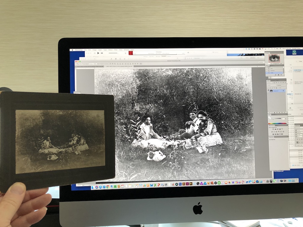 Holding up tintype photo next to photo in Photoshop