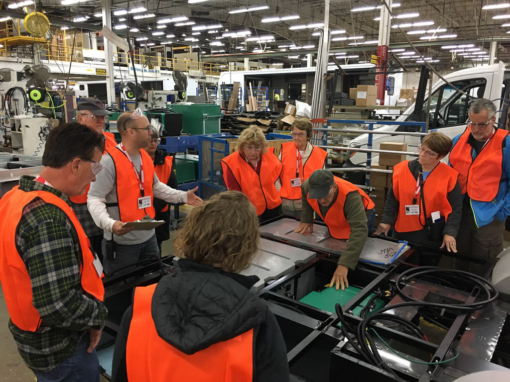 Group of people observing products on the production floor at the Winnebago facility.
