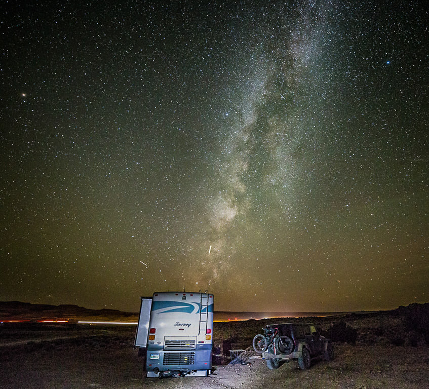 Winnebago Journey parked beneath the star filled night sky. 