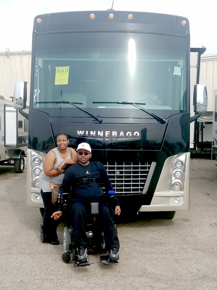 Jerome and Catrina in front of their new Accessibility Enhanced Winnebago Adventurer.