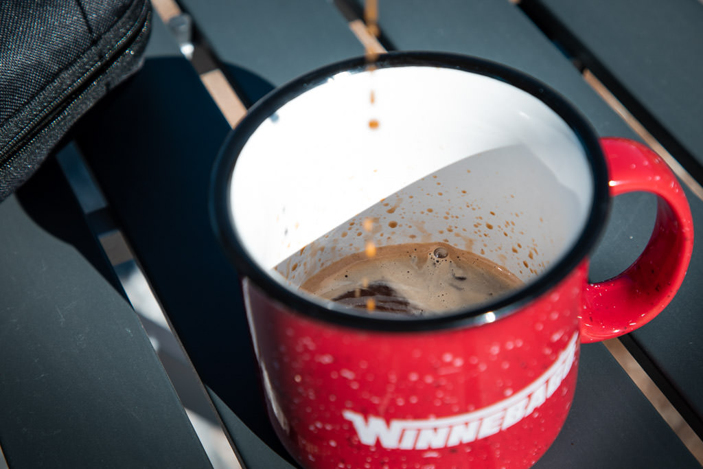 Detail view of coffeemaker dripping coffee into Winnebago mug