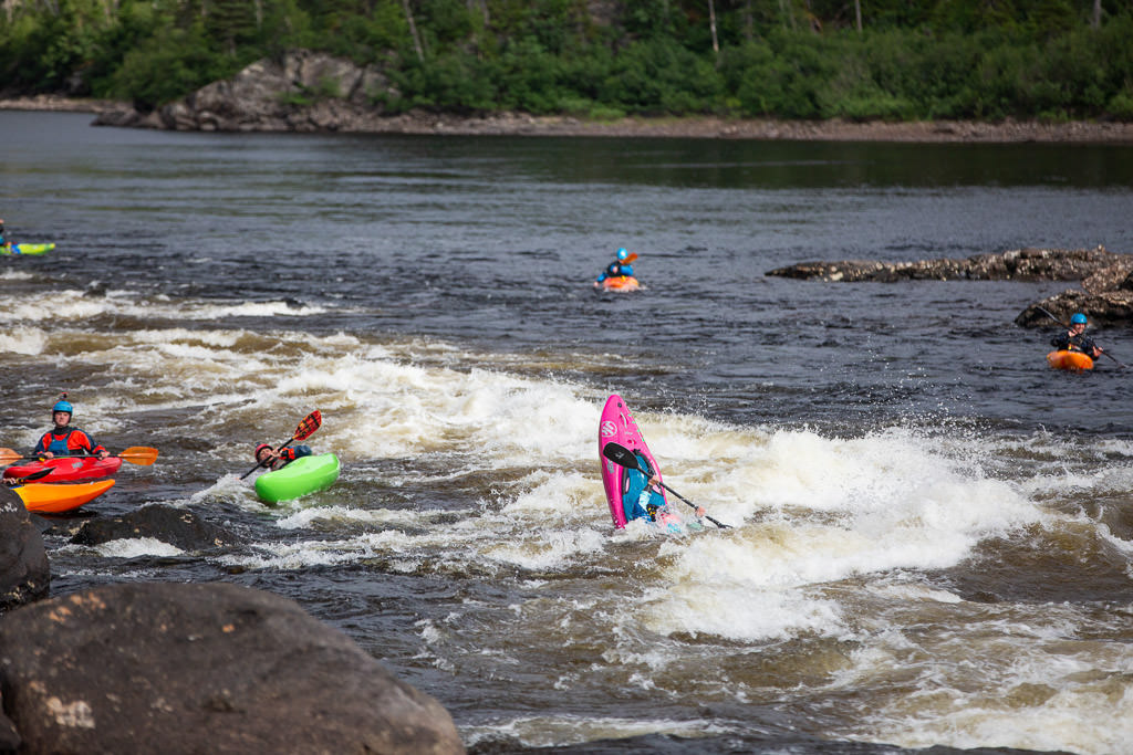 A few of the kayakers navigating small rapids.