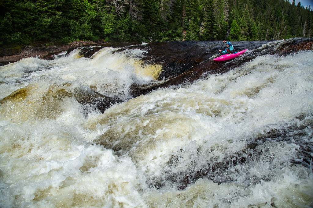 Abby dropping down in to a large rapid.