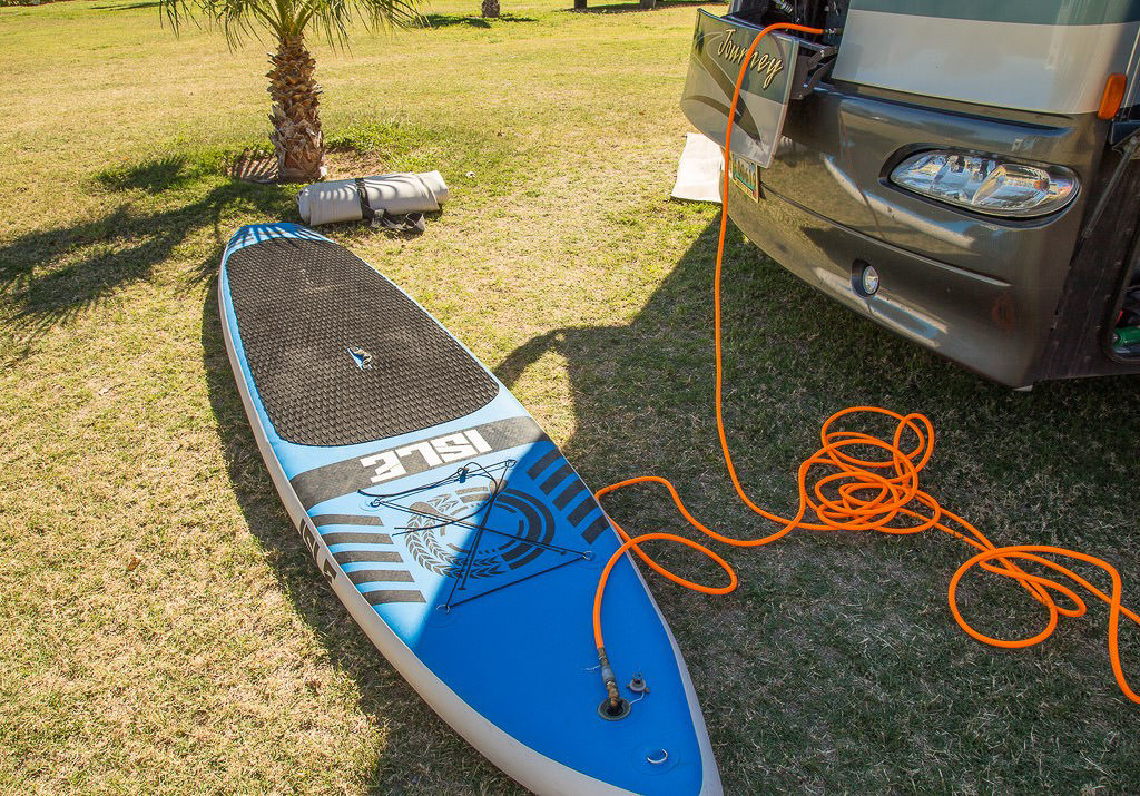 SUP board inflated using the onboard air compressor in Winnebago Journey