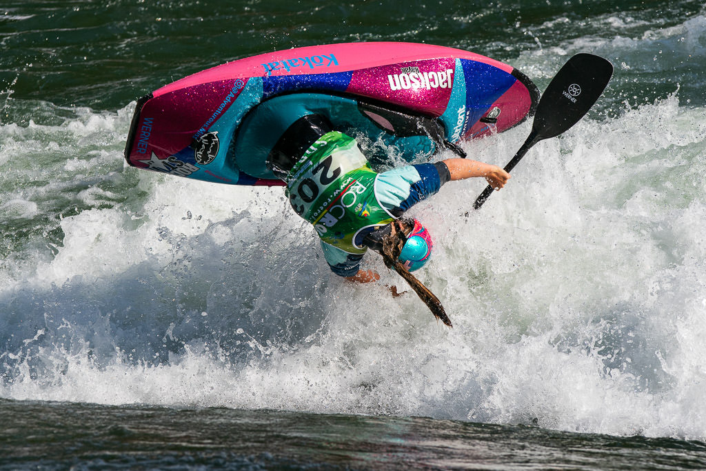 Kayaker flipped upside down above the water.