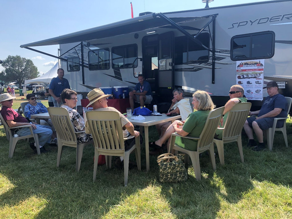 Group gathered outside a Winnebago Spyder during the 2019 Grand National Rally.