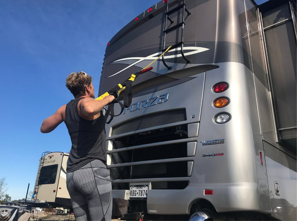Woman uses exterior components of RV for exercising
