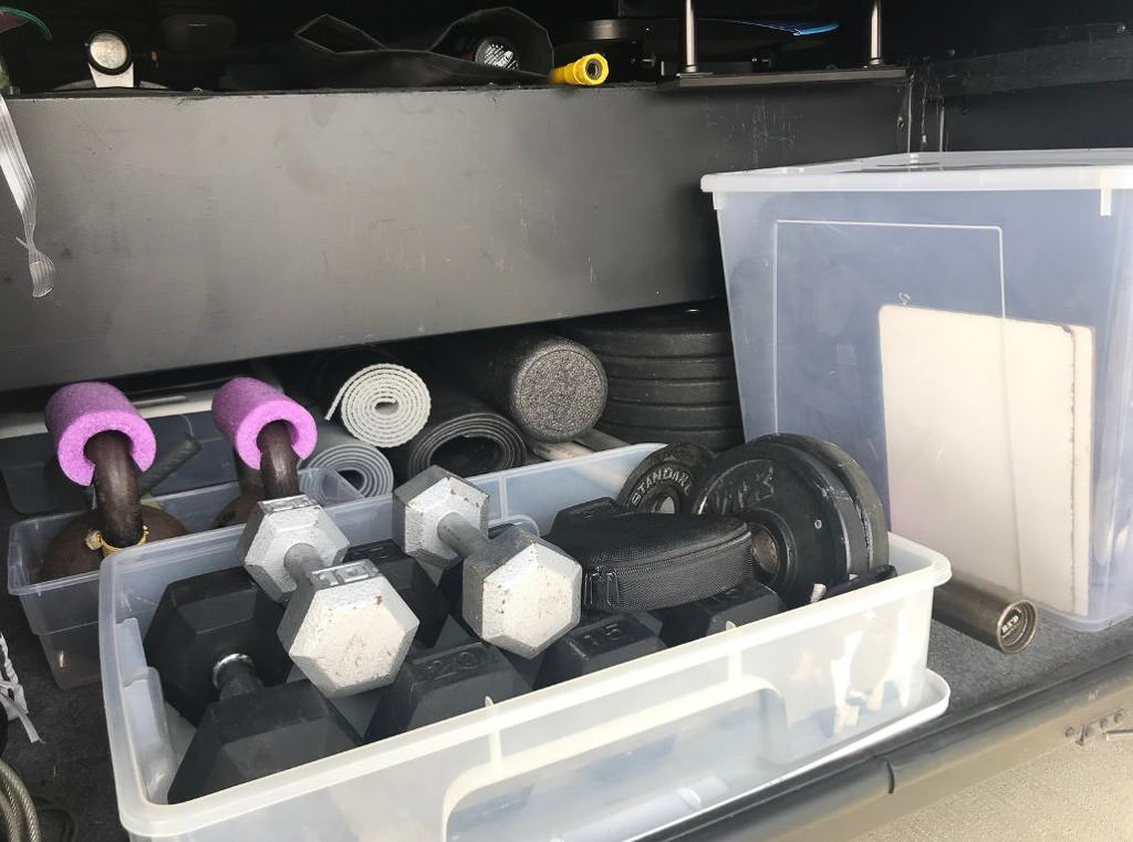 Organized workout equipment in exterior storage bay