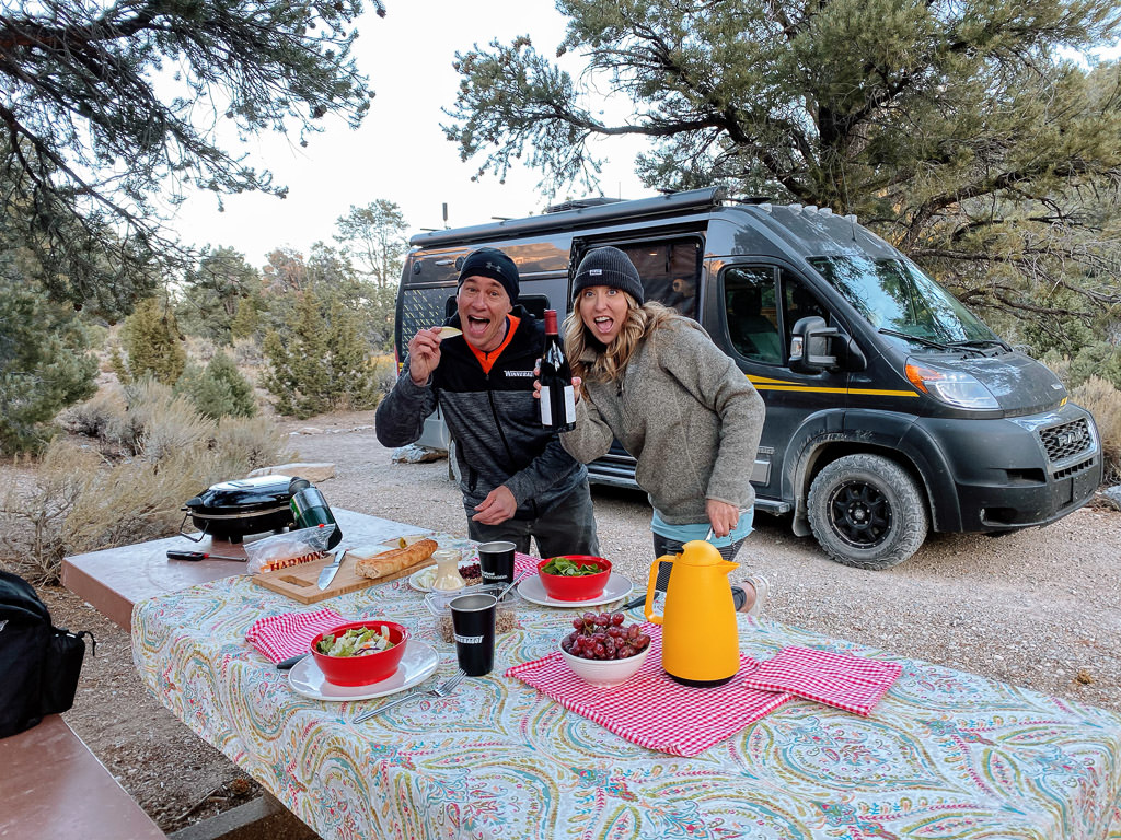 James and Stef having a picnic outside their Winnebago Limited Edition National Park Foundation Travato.